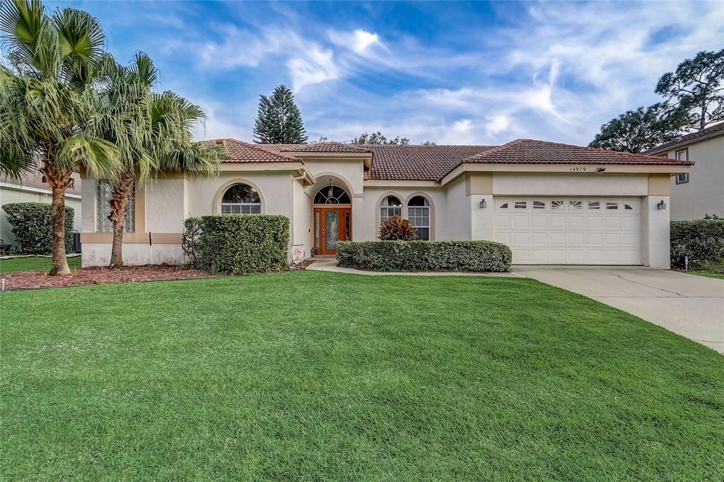 14979 Faversham Circle Orlando, FL 32826 - Photo 1 of 1 a front view of house with yard and green space