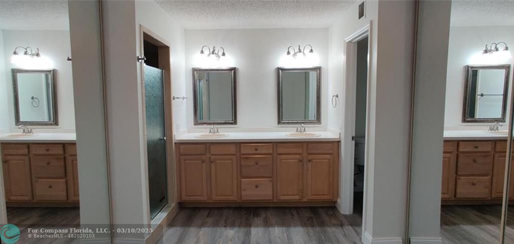 681 Springdale Circle Palm Springs, FL 33461 - Photo 16 of 17 a bathroom with double vanity sink and a mirror