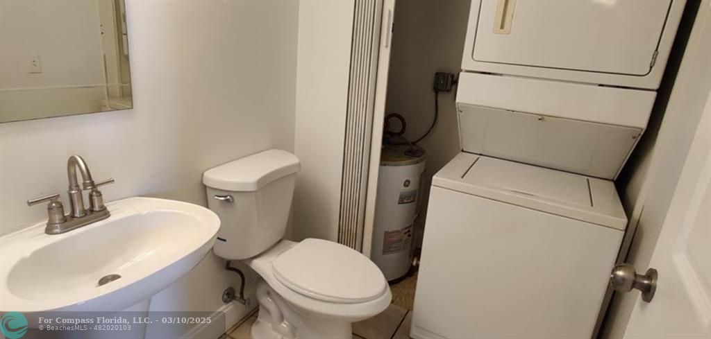 681 Springdale Circle Palm Springs, FL 33461 - Photo 10 of 17 a white toilet sitting next to a bathroom sink