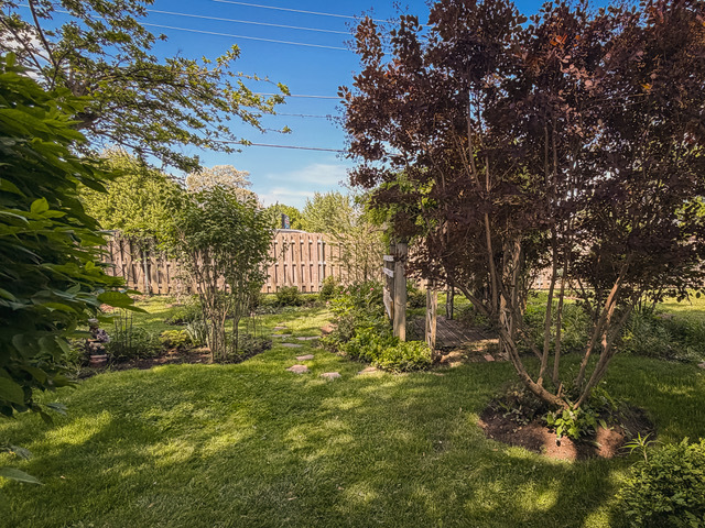 38569 North Sheridan Road, Unit 390 Beach Park, IL 60099 - Photo 25 of 28 a view of a yard with plants and large trees