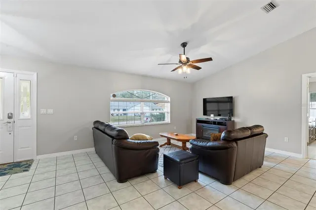 a kitchen with stainless steel appliances granite countertop a stove a refrigerator a sink a stove a dining table and chairs