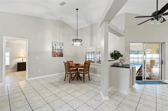 a view of a dining room with furniture and chandelier