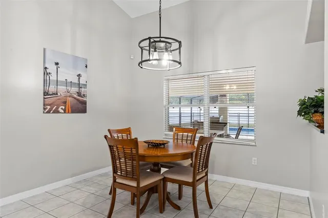 a view of a dining room with furniture and window
