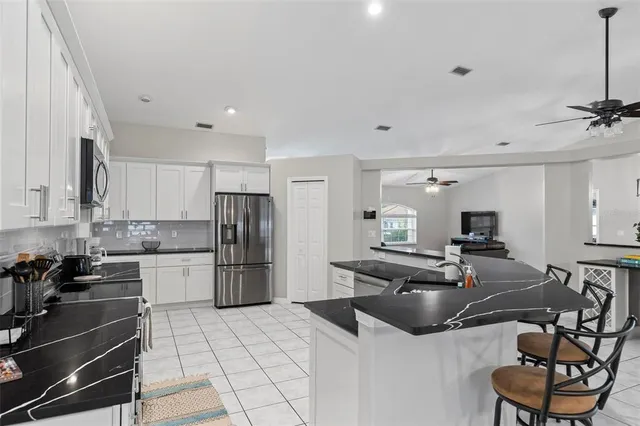 a view of a dining room with furniture a chandelier and a large window