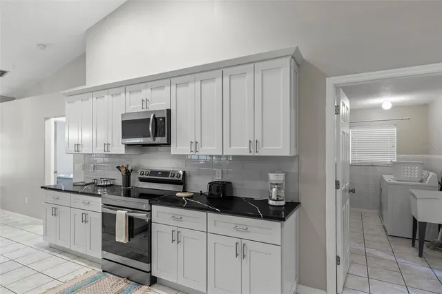 a bedroom with a bed and a desk with stool