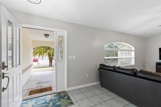 a view of a dining room and livingroom with furniture wooden floor a chandelier