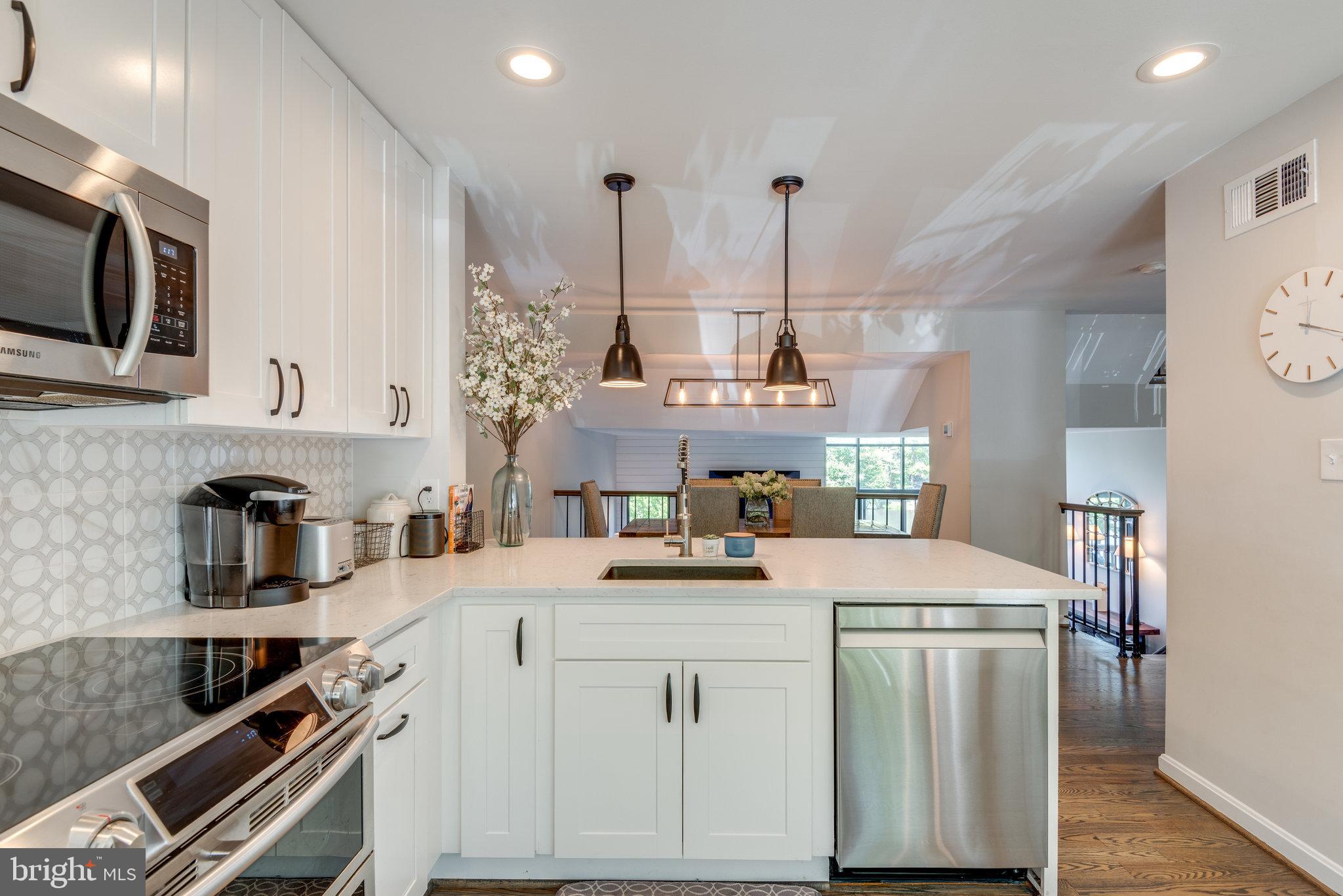10998 Thrush Ridge Road Reston, VA 20191 - Photo 13 of 40 Recessed and pendent lighting keep things bright
