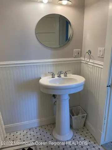 a bathroom with a sink a mirror and vanity