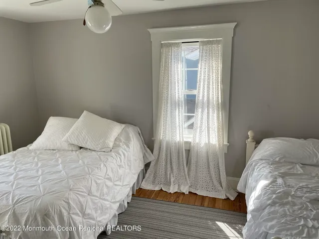 a bed sitting in a bedroom next to a window