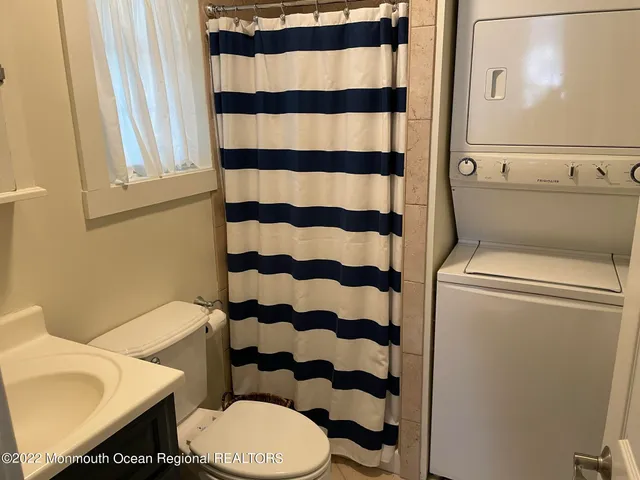 a white toilet sitting next to a shower curtain