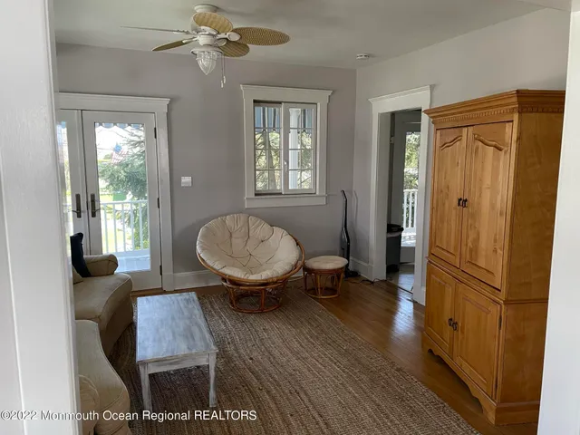 a room with wooden floor and a potted plant