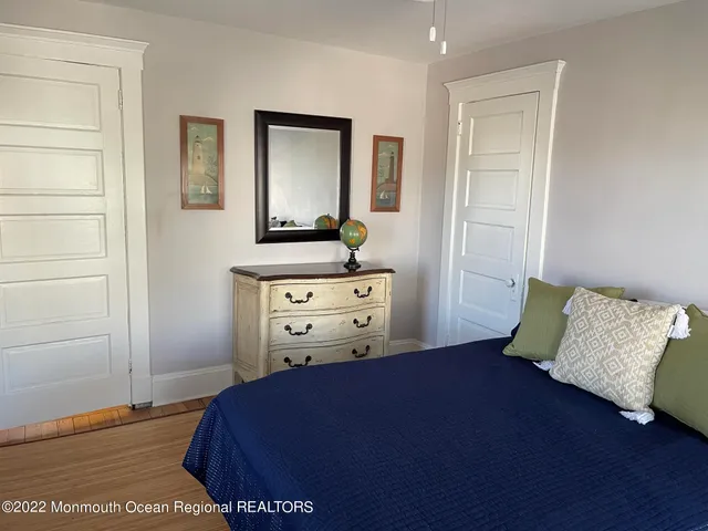 a bed sitting in a bedroom next to a bathroom