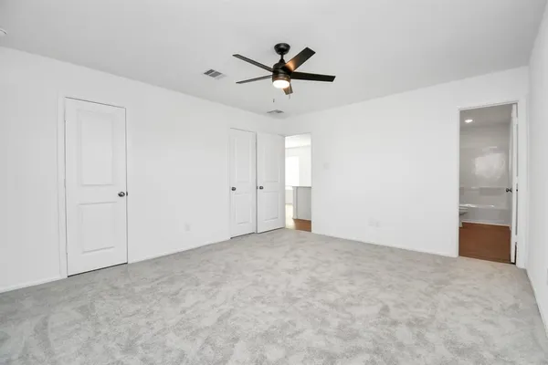 a bathroom with a double vanity sink a toilet and a bathtub