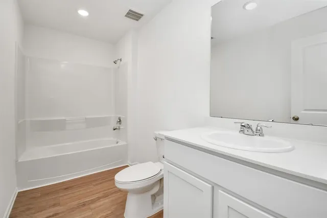 a bathroom with a sink a toilet and a bathtub