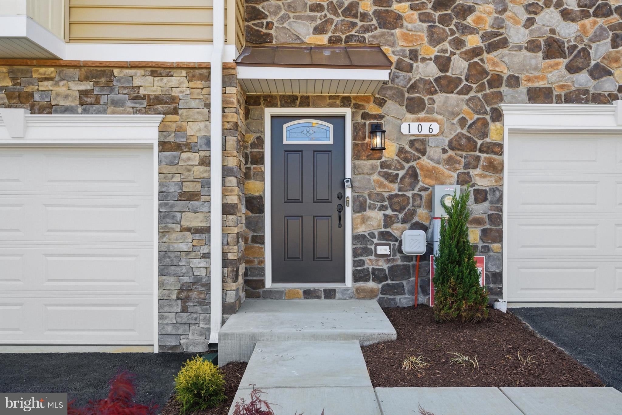 106 Potomac Court Prince Frederick, MD 20678 - Photo 2 of 47 a front view of a house with a garden