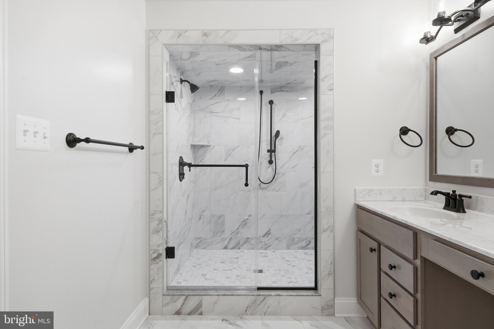 106 Potomac Court Prince Frederick, MD 20678 - Photo 27 of 47 a bathroom with a shower sink and mirror