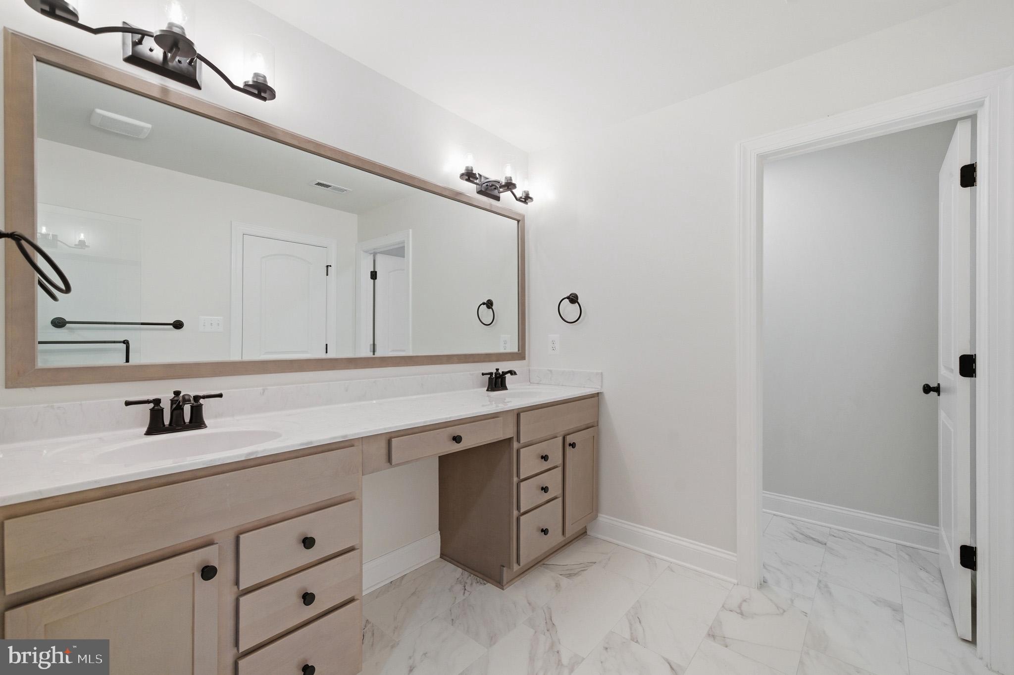 106 Potomac Court Prince Frederick, MD 20678 - Photo 30 of 47 a spacious bathroom with a double vanity sink a mirror and a bathtub