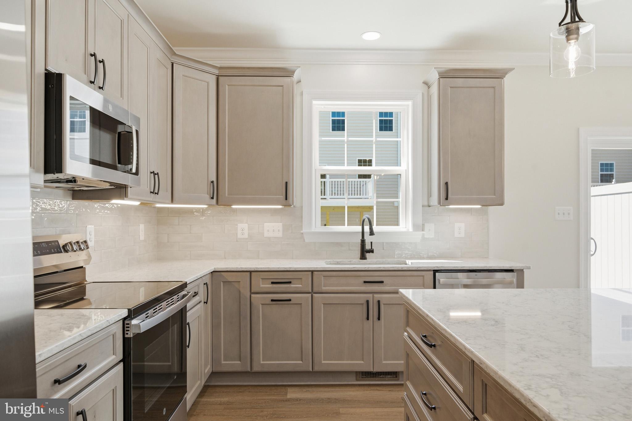 106 Potomac Court Prince Frederick, MD 20678 - Photo 10 of 47 a kitchen with stainless steel appliances granite countertop a sink stove oven and white cabinets