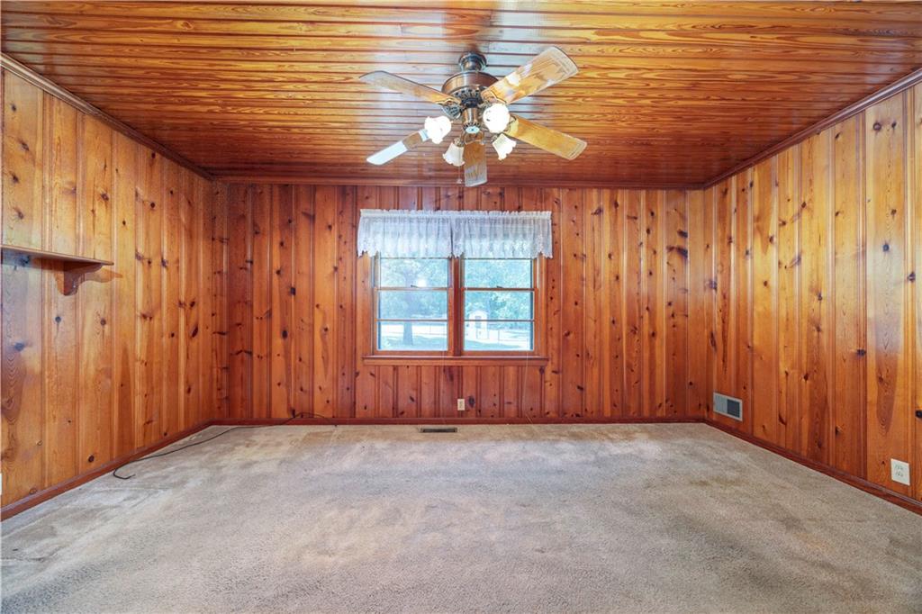 5201 Summerville Road Phenix City, AL 36867 - Photo 29 of 35 Empty room with wood ceiling, carpet floors, ceiling fan, and wooden walls