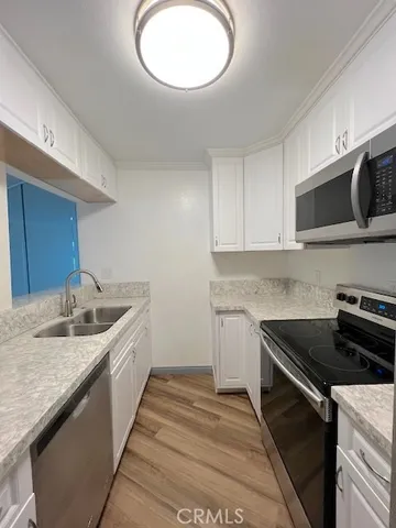 a kitchen with stainless steel appliances granite countertop a sink and a stove