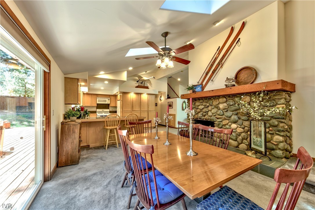 146 Tramway Road Incline Village, NV 89451 - Photo 13 of 34 a dining room with stainless steel appliances kitchen island granite countertop a table chairs and a view of living room