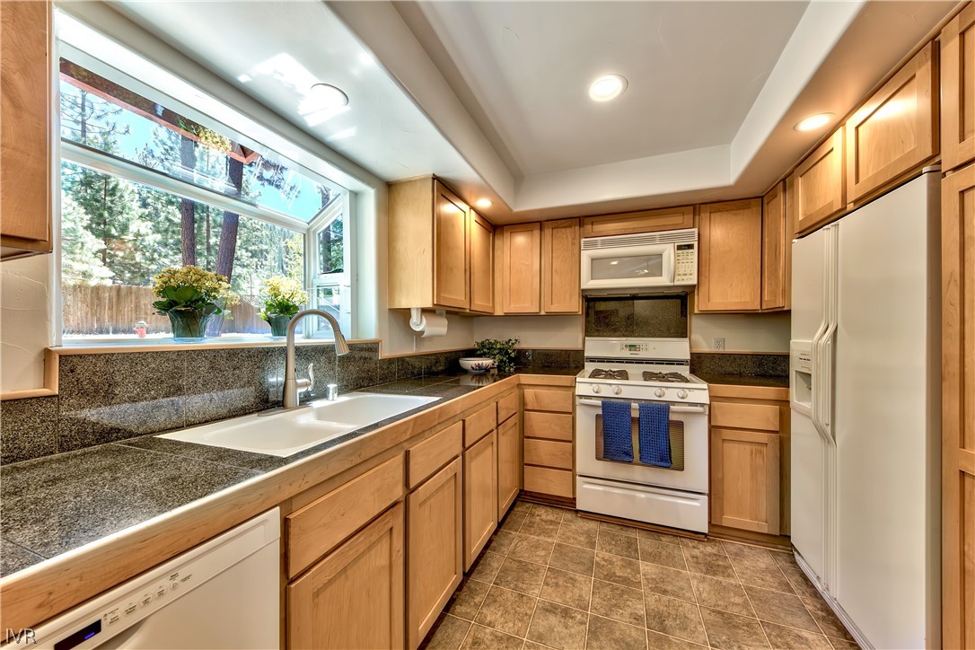 146 Tramway Road Incline Village, NV 89451 - Photo 16 of 34 a kitchen with stainless steel appliances granite countertop a sink a stove and a refrigerator