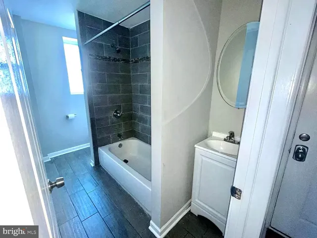 a bathroom with a tub a toilet and a sink