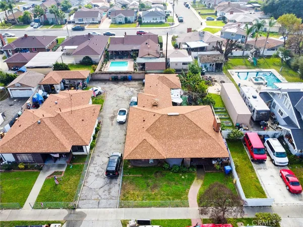 an aerial view of multiple houses with yard