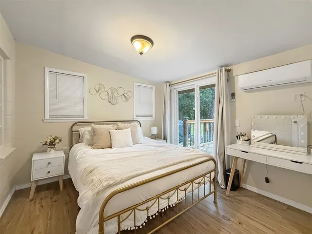 a bedroom with a bed and a large window