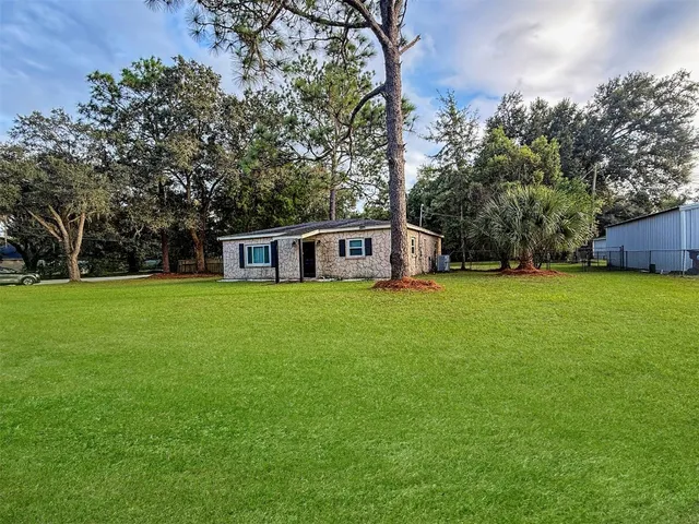 a house view with a sitting space and garden