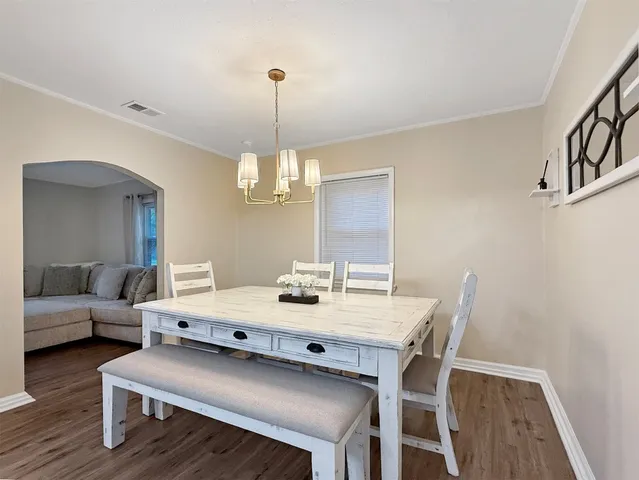 a view of a dining room with furniture wooden floor and chandelier