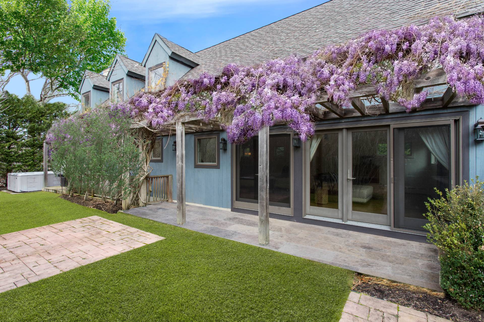 1095 Millstone Road Sag Harbor, NY 11963 - Photo 14 of 19 a front view of a house with a yard and a garden