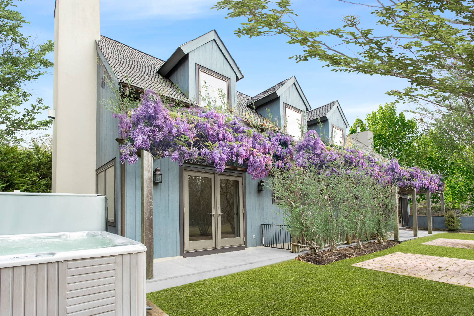 1095 Millstone Road Sag Harbor, NY 11963 - Photo 5 of 19 a front view of a house with a yard