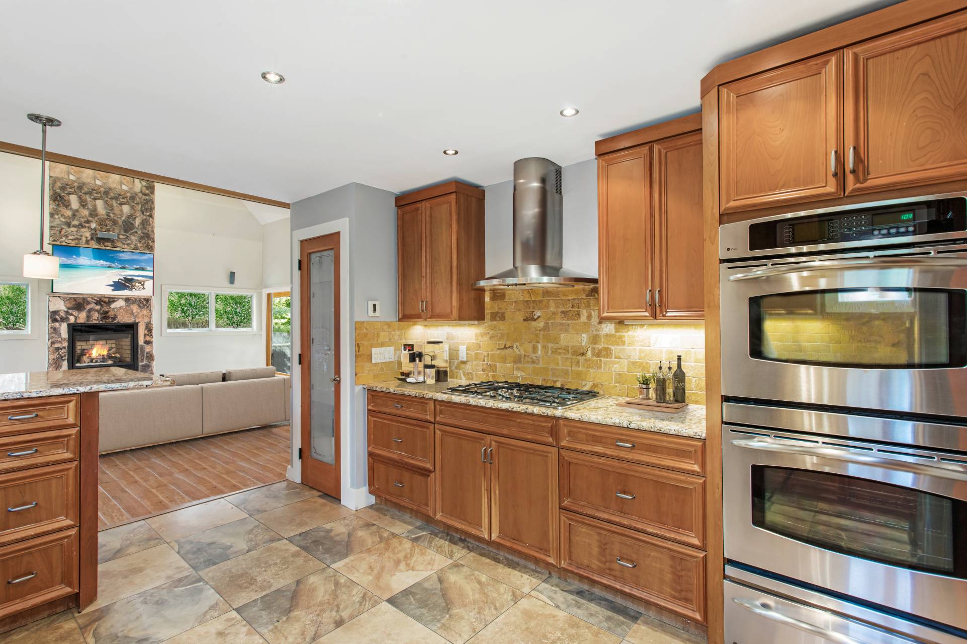 1095 Millstone Road Sag Harbor, NY 11963 - Photo 9 of 19 a kitchen with stainless steel appliances kitchen island granite countertop a stove a sink and a refrigerator