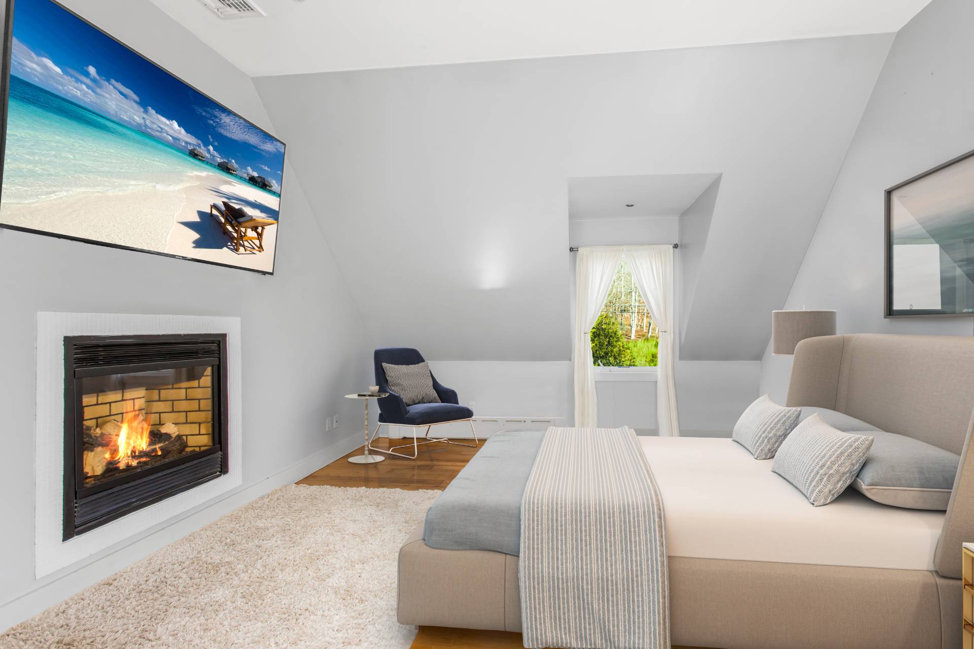 1095 Millstone Road Sag Harbor, NY 11963 - Photo 10 of 19 a bedroom with a bed and a lamp on dresser