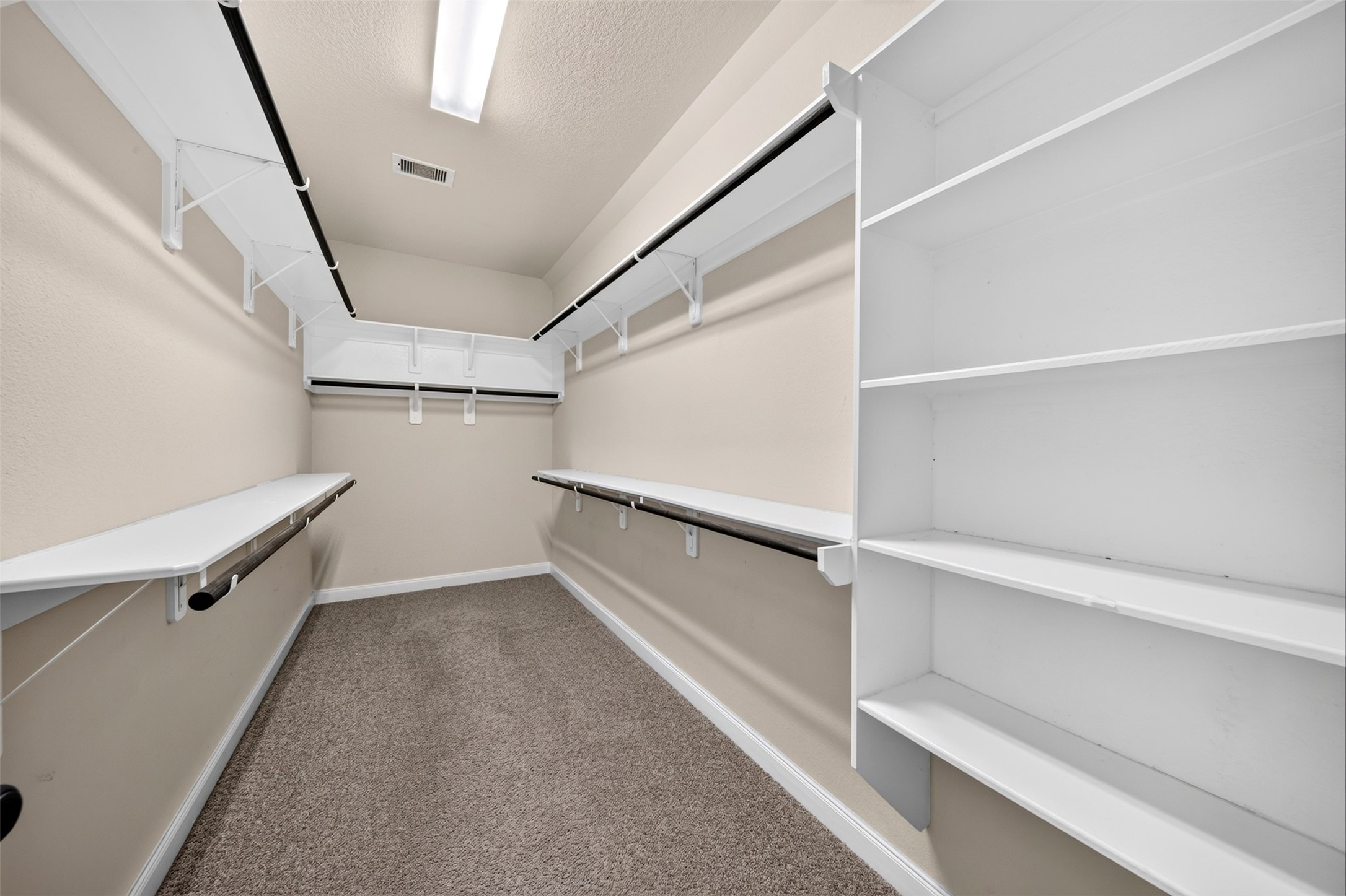6234 Avon Landing Lane Spring, TX 77379 - Photo 24 of 49 You are going to love this large walk-in primary bedroom closet that has plenty of space for hanging as well as folded clothes.