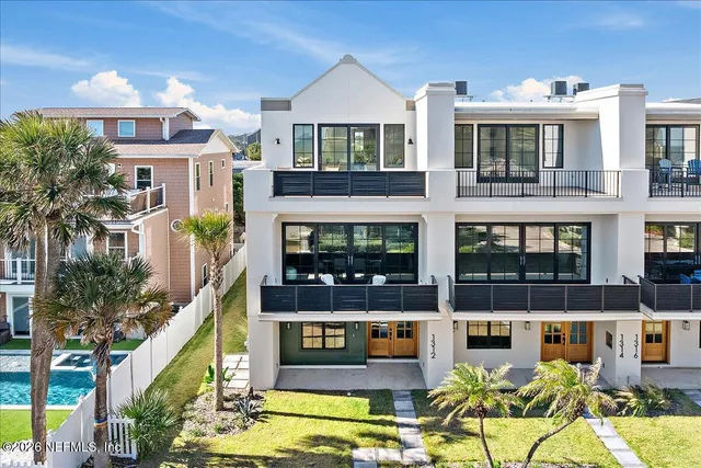 a front view of a building with a garden