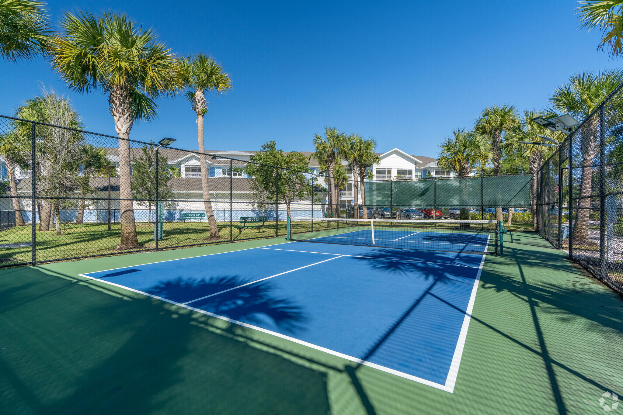 1924 Northwest Federal Highway, Unit 3418 Stuart, FL 34994 - Photo 17 of 18 a view of a tennis ground with large trees