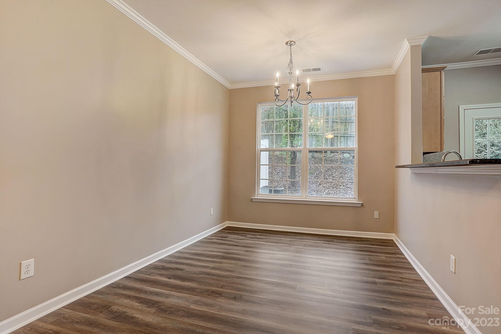 2119 Midnight Blue Lane Fort Mill, SC 29708 - Photo 3 of 15 an empty room with wooden floor and windows