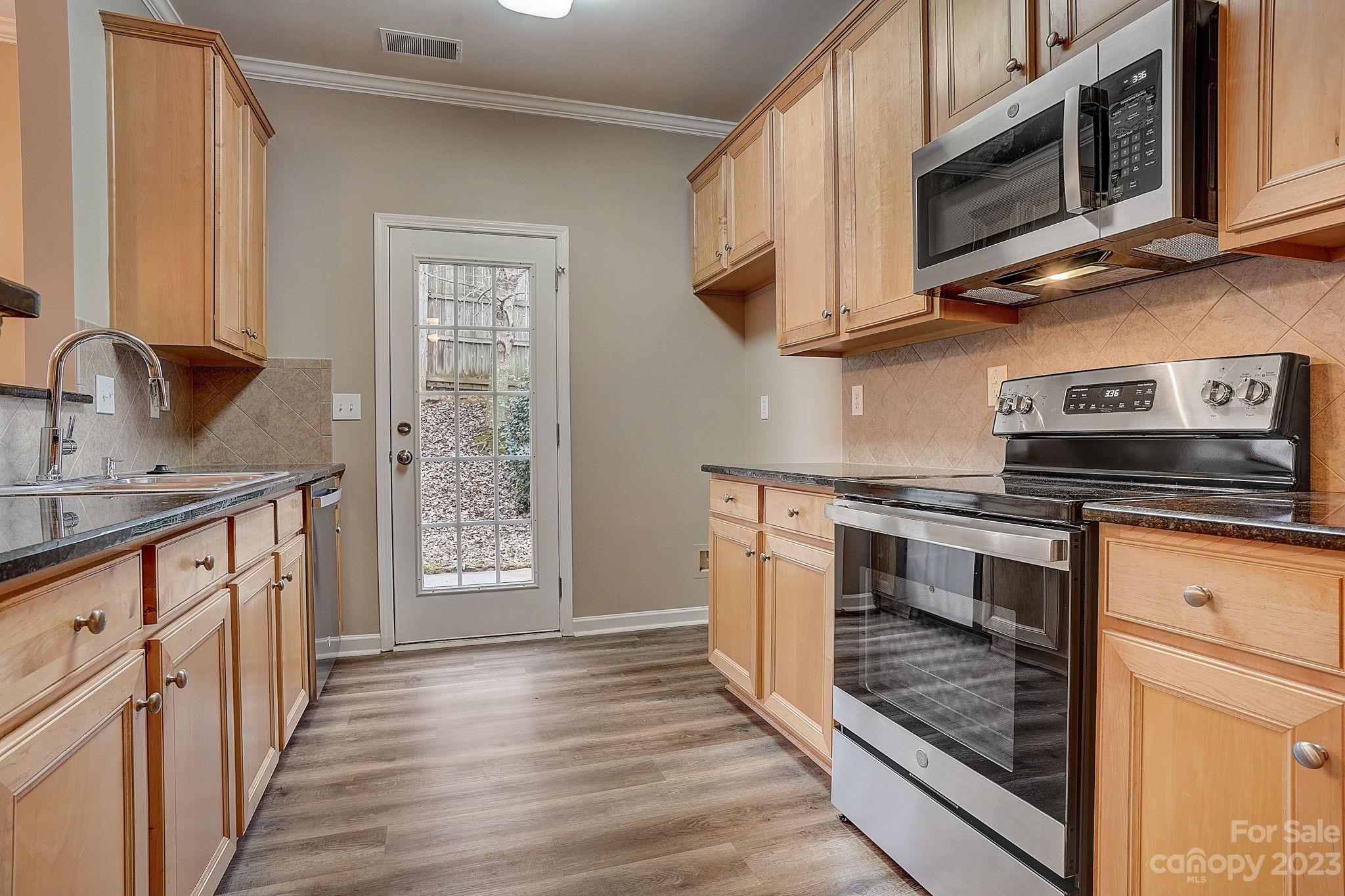 2119 Midnight Blue Lane Fort Mill, SC 29708 - Photo 4 of 15 a kitchen with stainless steel appliances granite countertop a stove and a microwave