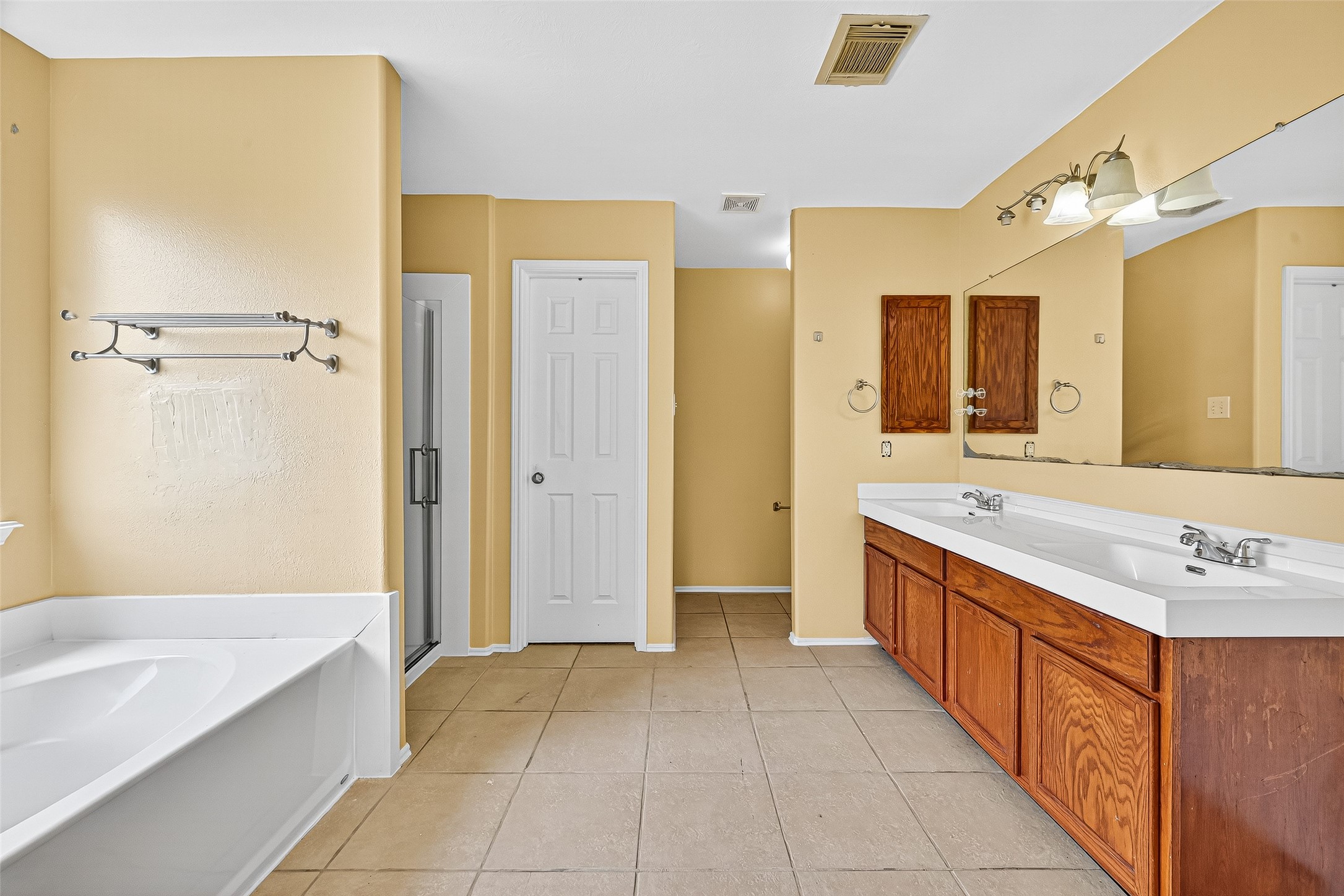 634 Hawthorne Pasture Road Rosenberg, TX 77471 - Photo 42 of 49 Unwind in the primary bathroom complete with double vanities, a soaking tub, and a separate glass-enclosed shower