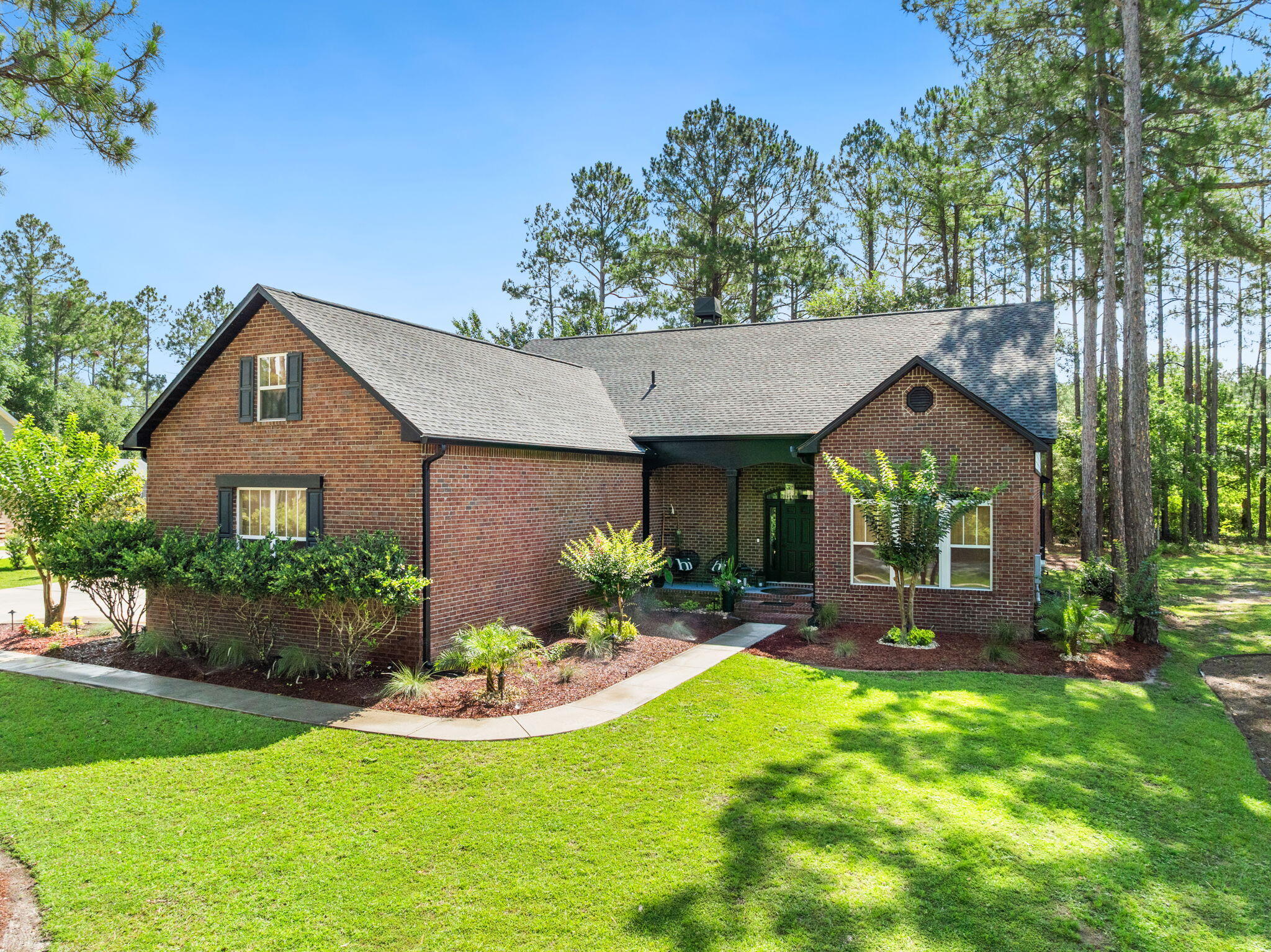 a front view of a house with a yard and porch
