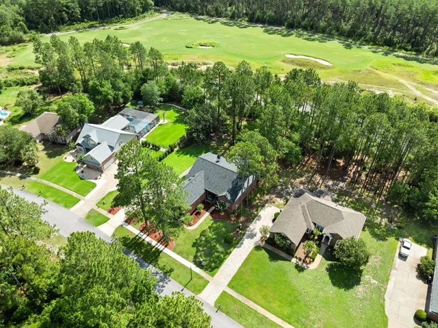 an aerial view of a house with yard swimming pool and outdoor seating