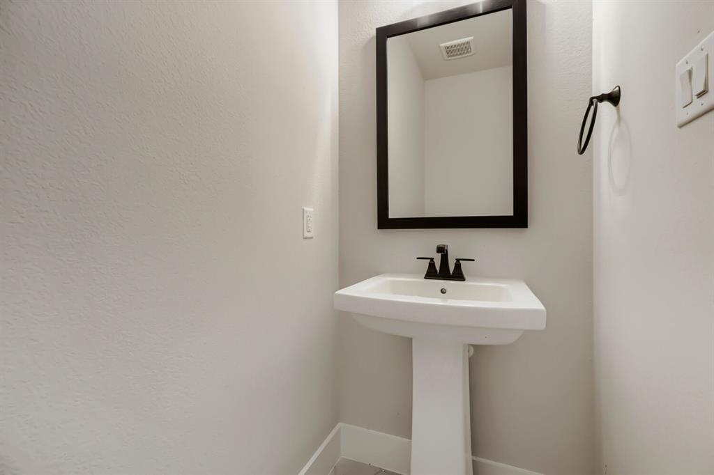 4414 Windy Point Road Oak Point, TX 75068 - Photo 11 of 27 a bathroom with a sink and mirror