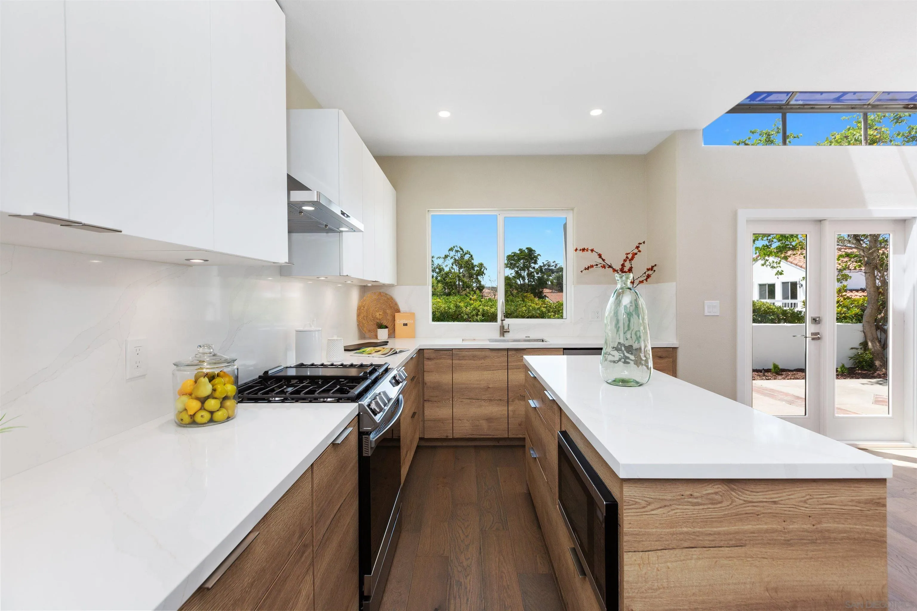 4963 Pylos Way Oceanside, CA 92056 - Photo 16 of 53 a kitchen with a sink a stove and cabinets