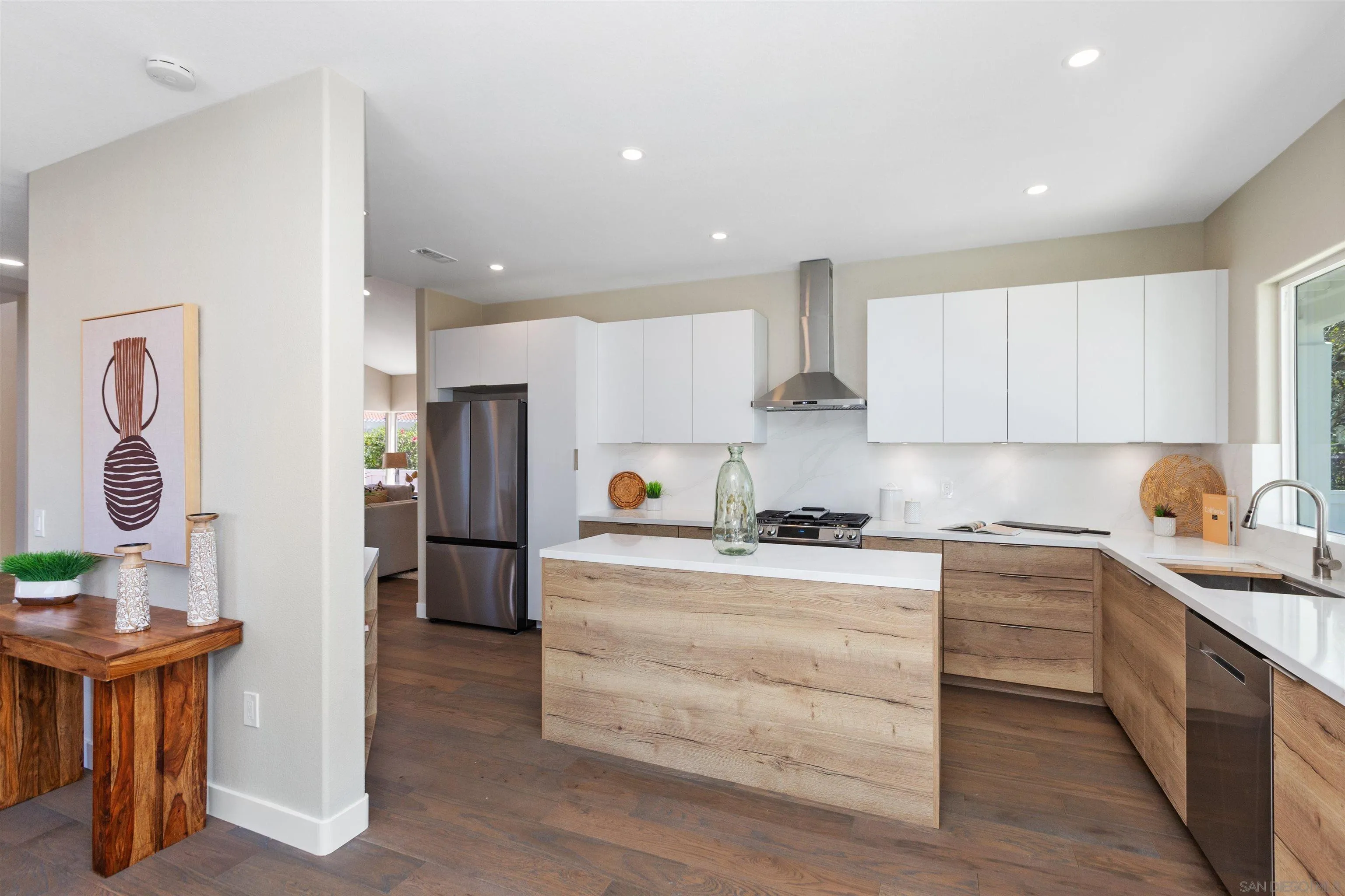 4963 Pylos Way Oceanside, CA 92056 - Photo 17 of 53 a kitchen with stainless steel appliances granite countertop a stove a sink and a refrigerator