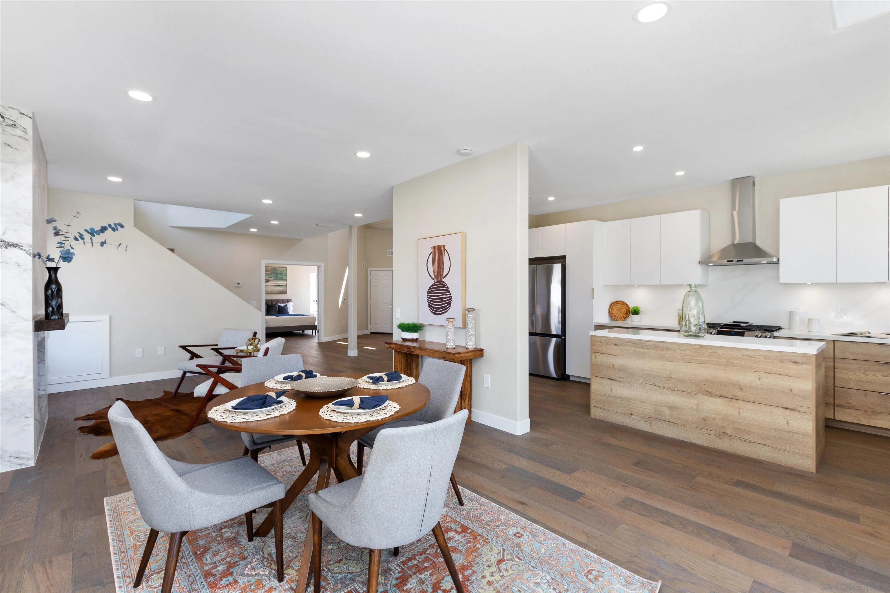 4963 Pylos Way Oceanside, CA 92056 - Photo 19 of 53 a view of a dining room with furniture and wooden floor