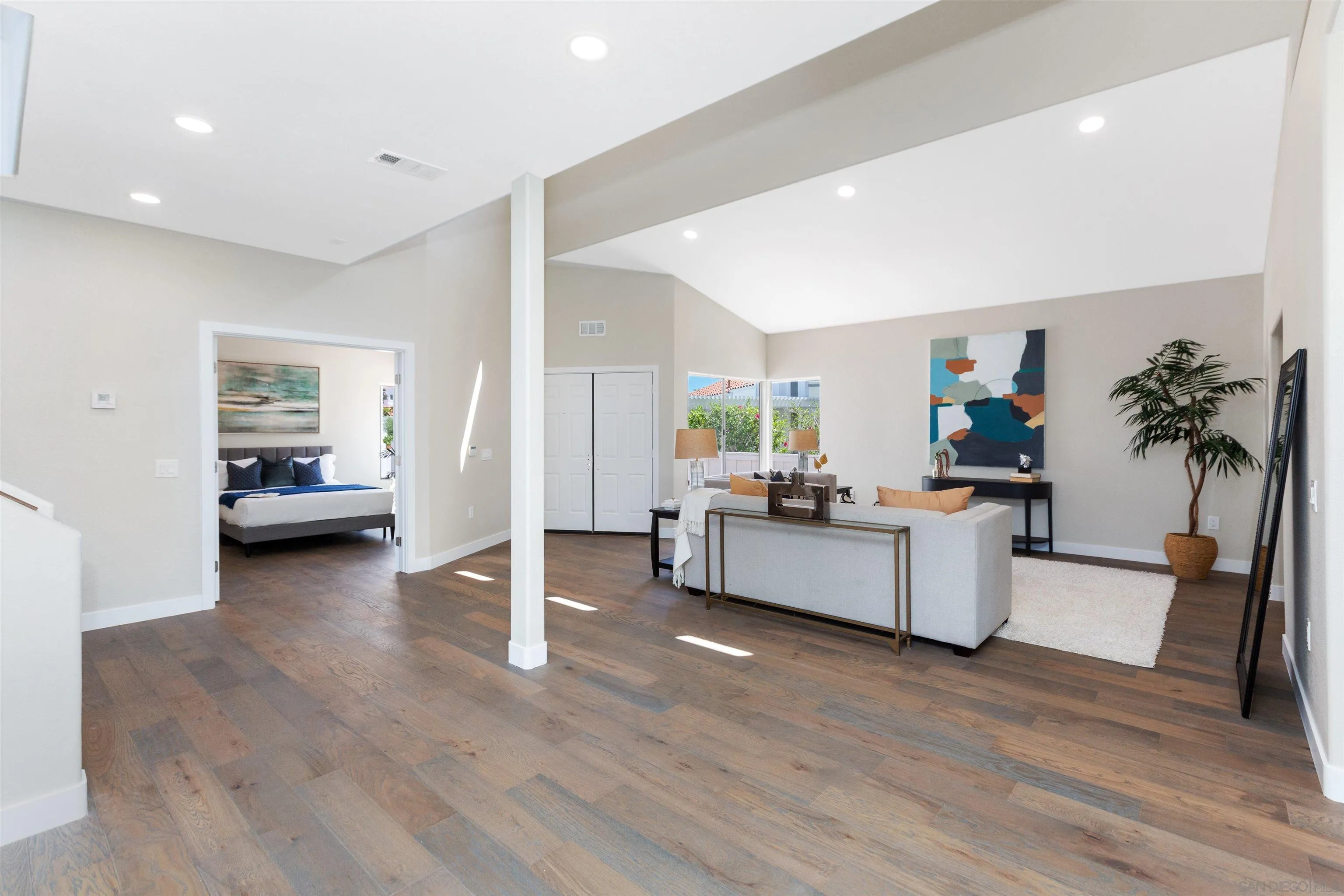 4963 Pylos Way Oceanside, CA 92056 - Photo 21 of 53 a living room with furniture and a large mirror with wooden floor