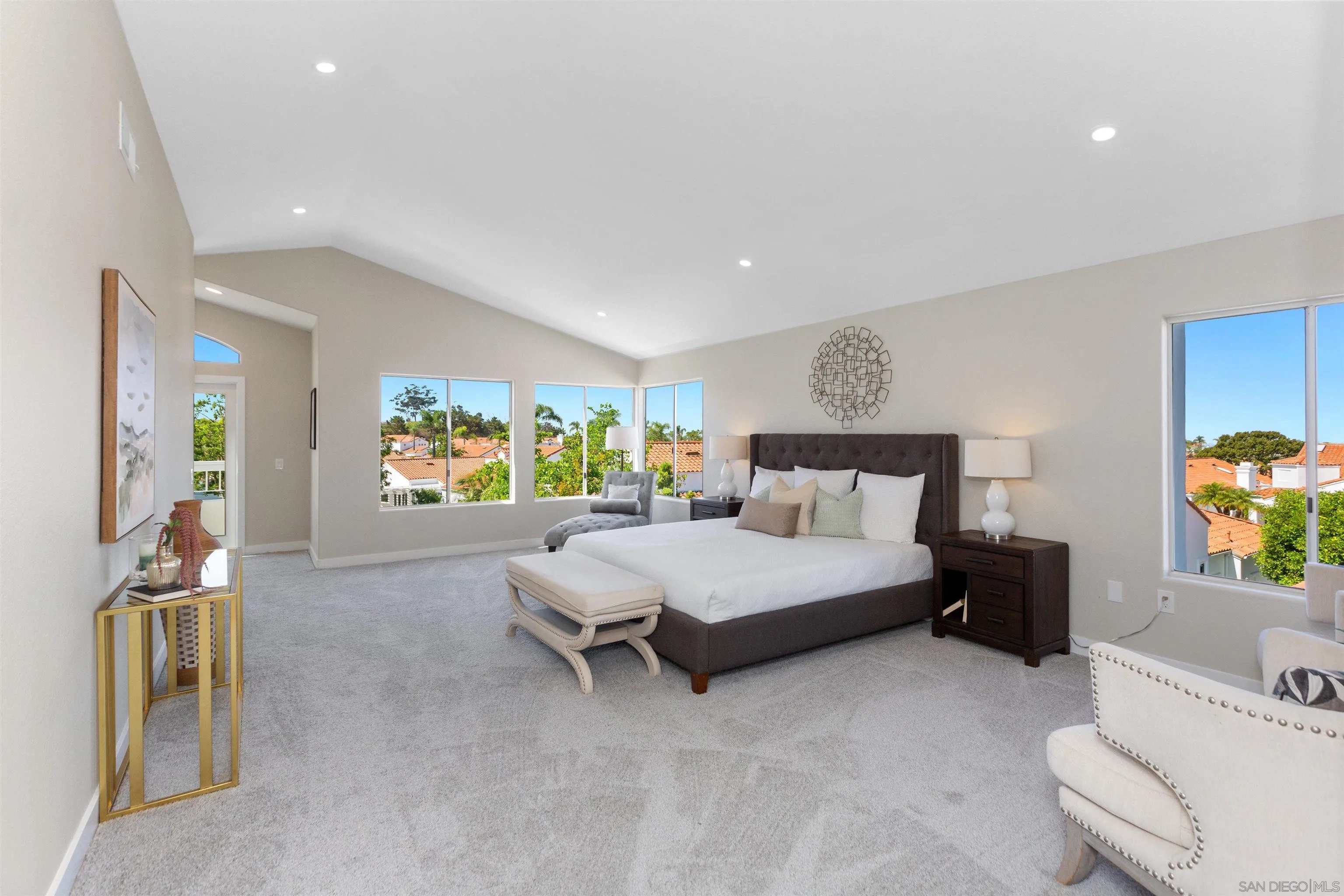 4963 Pylos Way Oceanside, CA 92056 - Photo 24 of 53 a spacious bedroom with a bed and a couch