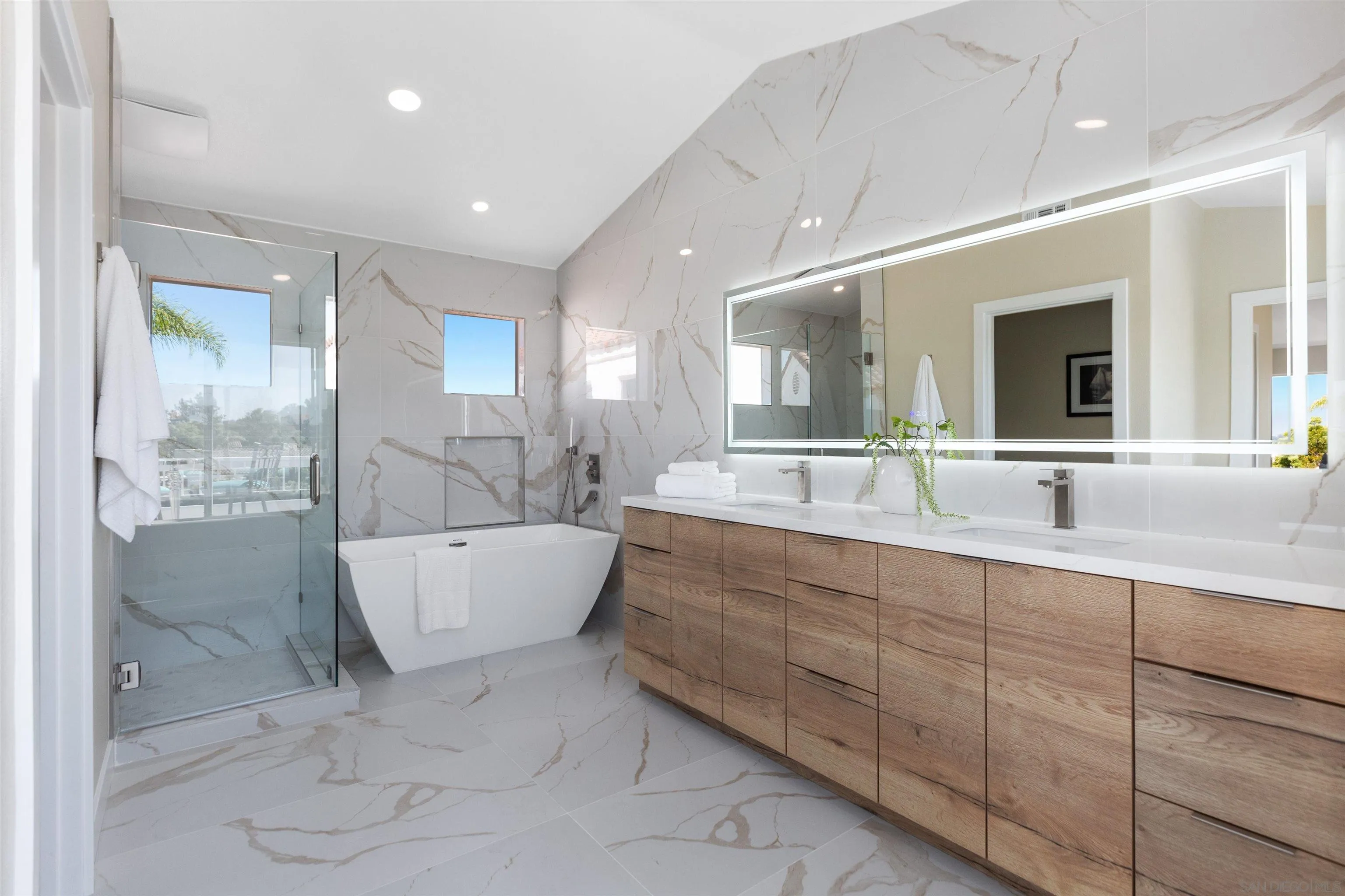 4963 Pylos Way Oceanside, CA 92056 - Photo 28 of 53 a bathroom with a large tub shower and sink